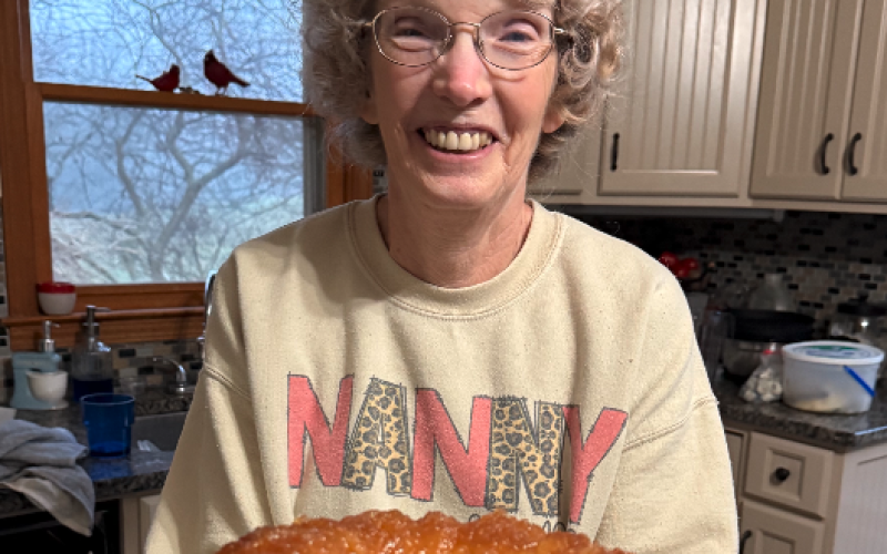 Nanny (Gail Leopard) holds our first creation this weekend – a pineapple juice cake. Photo by Rose Scoggins.