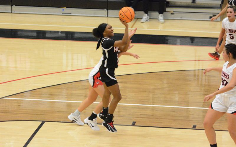 Junior guard Jaycee Wiley puts up a floater in the 63-33 win at Stephens County Feb. 10. Photo by Benjamin London.