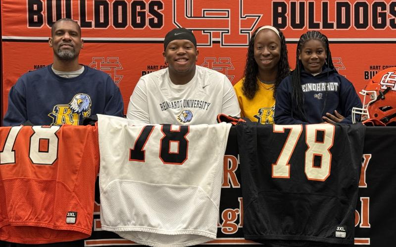 Pictured middle is Nicholas Carter with his family, as he signed with Reinhardt for football. Photo by Benjamin London.