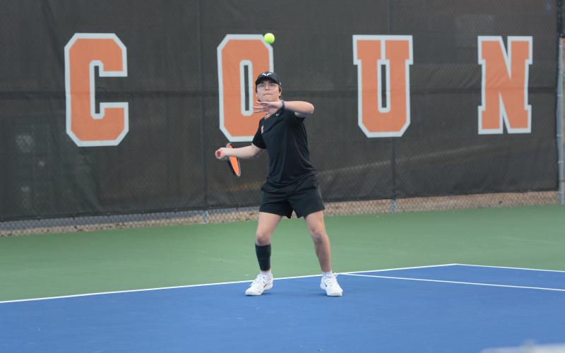 Riley Gaines returns a serve in the 5-0 win against Elbert County Feb. 9, as he remaines undefeated through three matches at No. 3 singles. Photo by Benjamin London.