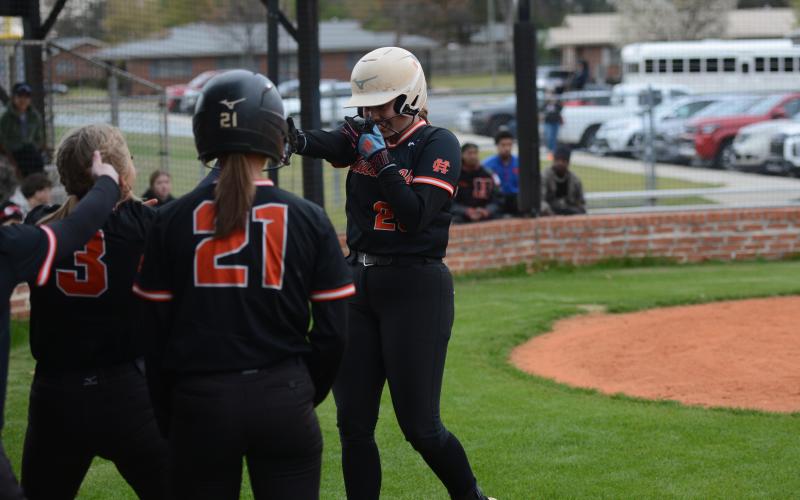 Chesnee Strickland (right) celebrates with her teammates after hitting a three-run home run to start the 21 run inning in the 21-1 game two  win against Hancock Central March 18. Photo by Benjamin London.