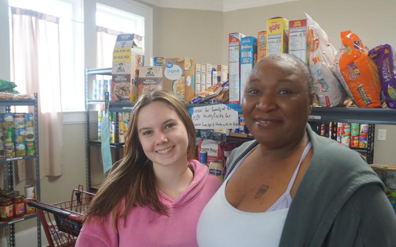 Assistant director Beth Mason and director Keisha Henry stock shelves at the Hart County Food Pantry on Mondays. The pantry offers perishable and non-perishable goods. Photo by Madison Linton.