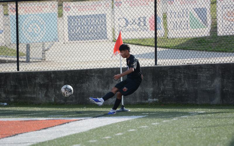 Midfielder Johan Santos Perez sends the ball into play earlier in the season, as he scored goal and collected an assist in the 3-0 win over East Jackson March 13. Photo by Benjamin London.