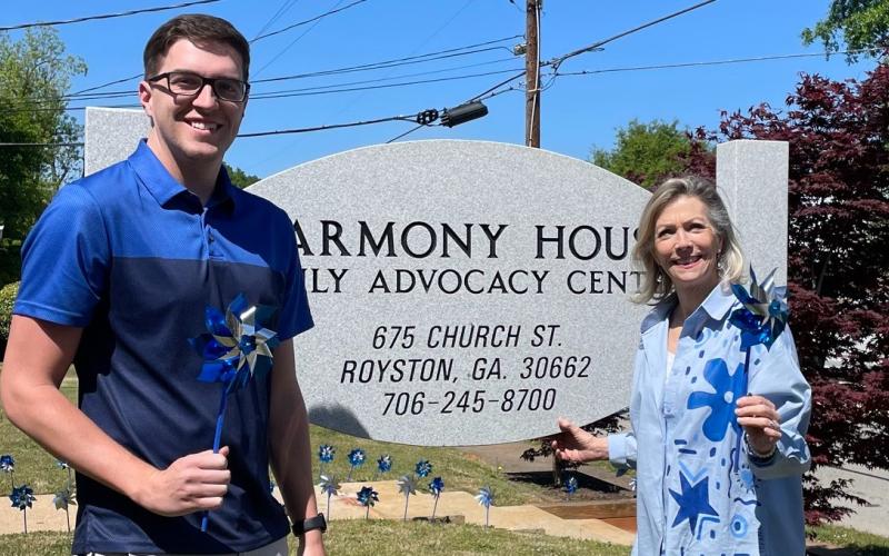 Harmony House's Darrin Haley, director of clinical services, (left) and Laurie Whitworth, executive director (right) wore blue and held pinwheels outside the organization's Royston office in recognition of Child Abuse Awareness Month earlier in April. The organization, which serves the counties that make up the Northern Judicial Circuit, including Hart County, serves victims of sexual assault and abuse across all ages. Photo courtesy of Harmony House Child Advocacy and Sexual Assault Center.