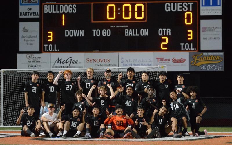 Photo by Benjamin London The Hart County High School boys soccer team celebrates after their historic 1-0 win over the Lions of Hebron Christian March 31, as they set school history capturing their 13th win of the season. Photo by Benjamin London.