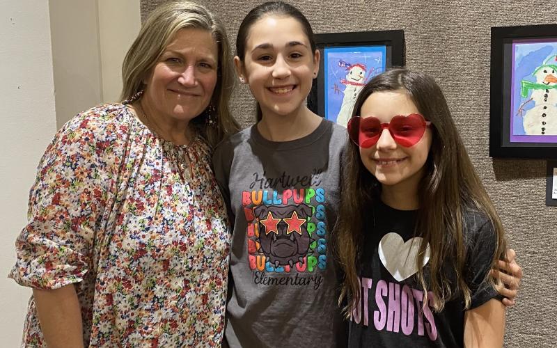 April Garner is pictured with students (L-R) MaKinley Cleveland and Savannah Shultz at the opening of the Youth Exhibit at the Hartwell Art Center on April 3. (Photo courtesy of April Garner)