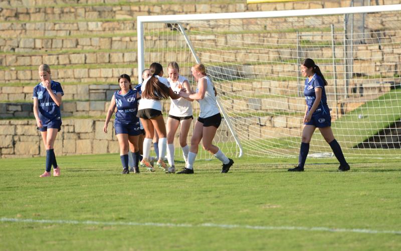 Isla Bell (middle) celebrates with her teammates after scoring a late goal in the 5-2 win over Elbert County April 14.  (Photo by Benjamin London)