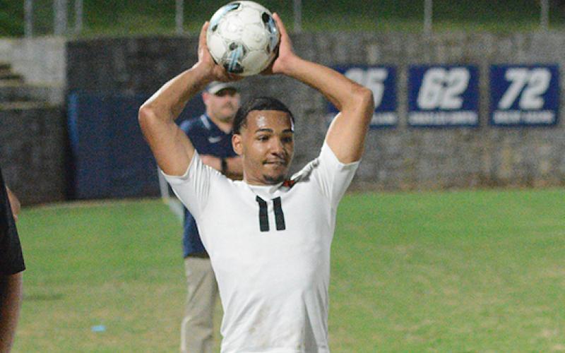 Elijah Garnett throws the ball into play, as he had an assist in the 7-2 win over the Blue Devils of Elbert County April 14. (Photo by Benjamin London)