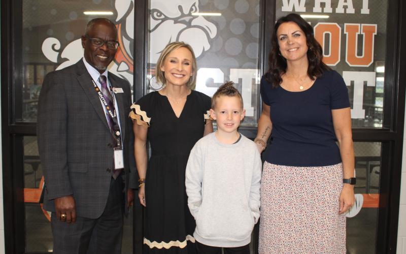 Pictured (L-R), are North Hart Elementary Assistant Principal David Pressley, Principal Christina Weir, second-grade student Parker Holmes and  second-grade teacher Amy  Martin. Photo by Grayson Williams.