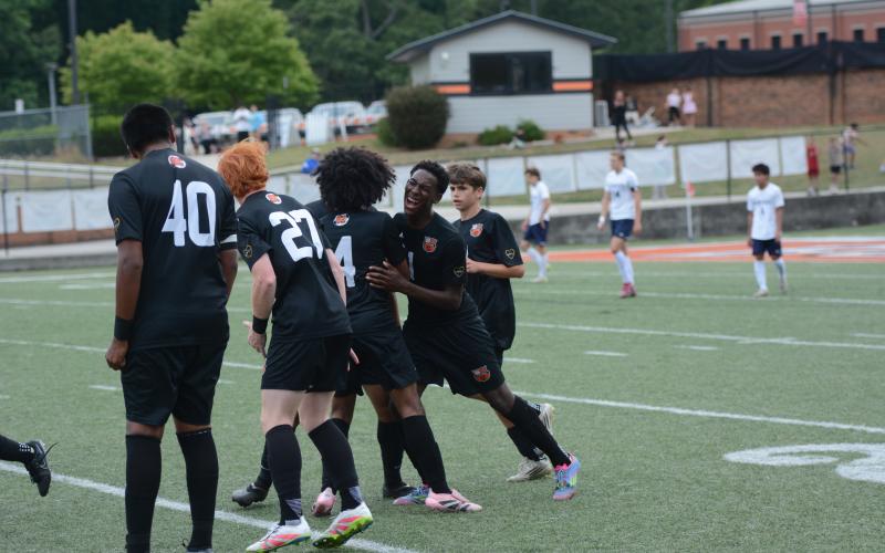 Cayson Craft celebrates with his teammates after scoring the lone goal in the 1-0 win over the Eagles of East Jackson in the Sweet Sixteen May 1. Photo by Benjamin London.