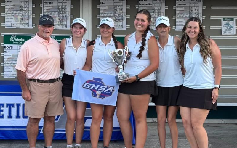 The Lady Dogs pose with the State Championship trophy after capturing the state title in Blackshear at the Okefenokee Country Club May 18-19.  Photo submitted by Hart County Golf.