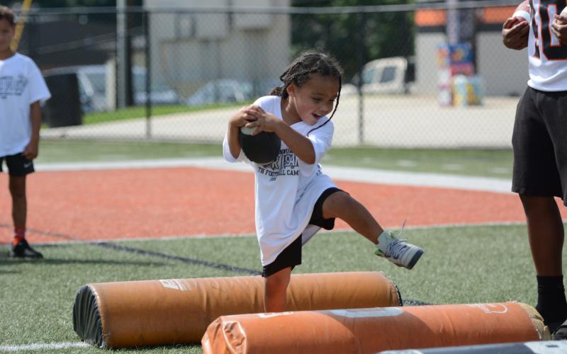 Campers compete in multiple offensive and defensive position drills in the second annual Harper Island Training Youth Football Camp lead by Class of 2004’s Mikendric Harper (pictured middle) June 20. Photo by Benjamin London.