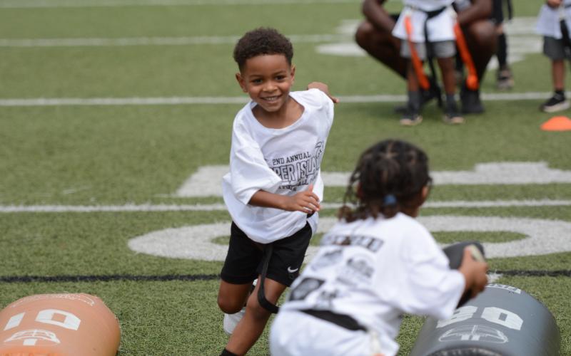 Campers compete in multiple offensive and defensive position drills in the second annual Harper Island Training Youth Football Camp lead by Class of 2004’s Mikendric Harper (pictured middle) June 20. Photo by Benjamin London.
