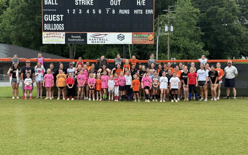 Pictured is the 30 plus campers, current players and coaches who attended or help lead the annual Little Bulldog Softball Camp June 8-10.  Photo by Benjamin London.