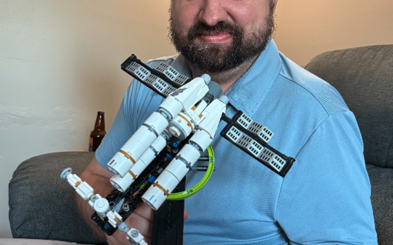 Michael holds one of the three Lego sets we've put together in the past month, the spaceship from the movie "Project Hail Mary." Photo by Rose Scoggins.