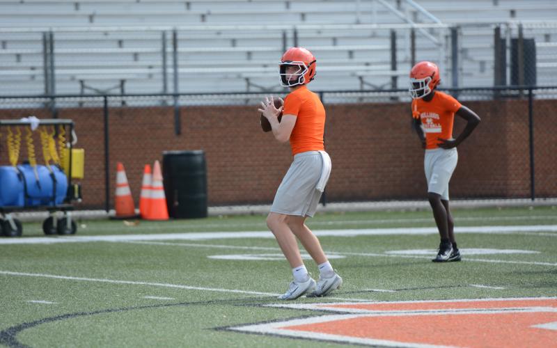 Sophomore quarterback Tucker Parson scans the field during a practice drill on July 16. Photo by Benjamin London.