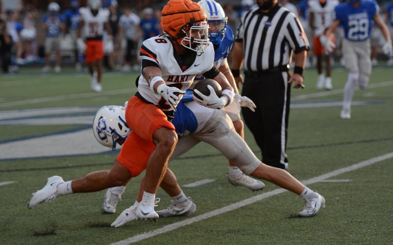 Pictured is senior running back Kaidyn Allen as he breaks multiple tackles for a big run down the sideline. Photo by Benjamin London.