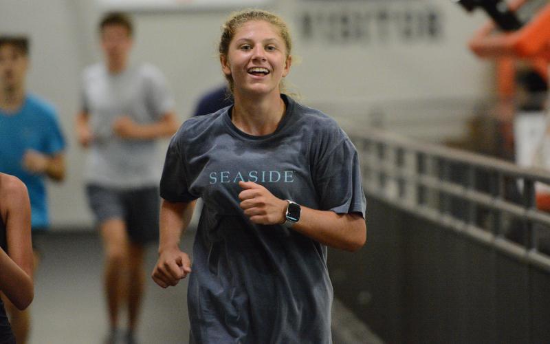 Freshman runner Posie Phillips jogs around the indoor track at the Hart County High School gym during a practice July 29. Photo by Benjamin London.