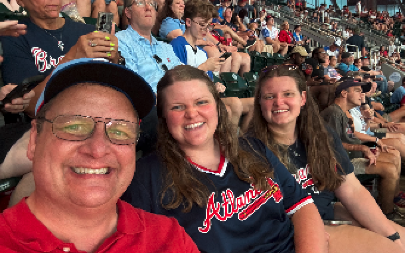 After three games of watching the Braves lose and two more with rain delays, we've decided our Scoggins family trio is cursed. We were able to get in this selfie before the rain poured last Thursday. Pictured are (L-R) Shane, Rose and Marlie Scoggins. Photo courtesy of Rose Scoggins.