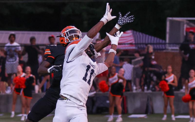 Senior running back and defensive back Xavier Allen goes up to break up the pass against a Raiders’ wide receiver in the 51-3 win Aug. 21. Photo by London Todd.