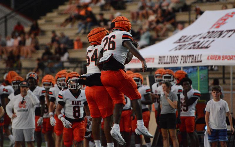Junior running back Zeebo Harper (26) celebrates his touchdown run with junior lineman Kalik Pickens (54) in the 34-26 win over Oconee County Aug. 13. Photo by Benjamin London.