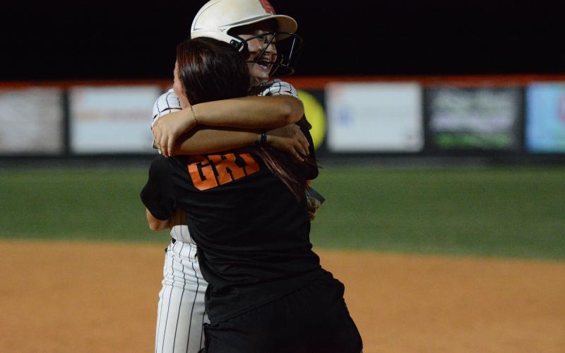 Freshman outfielder Peyton Jordan celebrates with assistant coach Kalyn Jinks after walking it off against the Lady Bulldogs of Morgan County Sept. 1, 9-8.  Photo by Benjamin London.