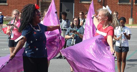 Flag corps members Detricunna Teasley, left, and Samantha Campbell, right, practice their flag routine during Hart County High School band camp on Monday. 