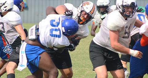 Hart County offensive lineman Caden Hart torques a Cedar Shoals defensive lineman last week at a full-contact camp in Habersham County. 