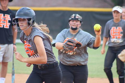 Sunshot by Grayson Williams — Freshman Emilee Sanders, left, tries to escape a pickle during a drill at Hart County High School softball practice Monday as Hannah Segars, right, tries to get Sanders out. 