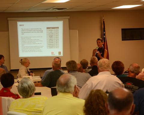 Sandy Campbell talks to property owners during a meeting about permit fee increases for shoreline activities.