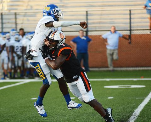 Sunshots by Grayson Williams — Defensive end Kaimon Rucker, above, hits the Tigers’ quarterback as he throws during the practice game. 
