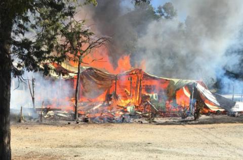 Photo submitted -- The Lake House Tavern is engulfed in flames Saturday morning on Rock Springs Road in Hart County.