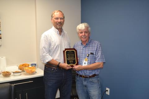 Terry Norton, right, retired this week after 50 years of service to Royston LLC. Norton was presented with a plaque commemorating his five decades of hard work by engineering manager Ben Credle, left.