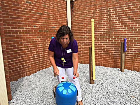 Photo submitted by Anna Hall — North Hart Elementary School music teacher Holly Fredericks plays her favorite addition to the school’s recently completed sound garden: a propane tank painted blue has been turned into a tank drum. 