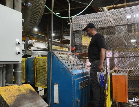 Sunshots by Michael Hall — Thomas Newman stands behind the draw bench where he once worked during his time at the Tenneco/Monroe facility Hartwell. 