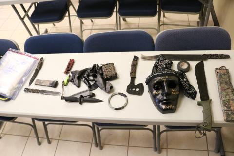 A bag of methamphetamine, at left, allegedly taken from a Hart County man, and knives, a hatchet, machetes, a mask and other items, allegedly taken from people out to kidnap and kill the man, are shown.