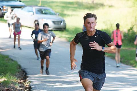 Sunshot by Grayson Williams — AJ Johnson runs up a hill recently at Hart County High School cross country practice. 