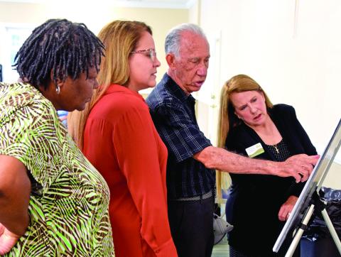 Photo by Shane Scoggins/Franklin County Citizen-Leader — Kool Farm LLC owner Pedro Galvin shows off plans for his new plant to be built in the Central Franklin Industrial Park during a reception following a ground breaking for the new industry Friday.