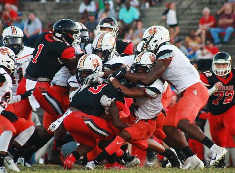 Sunshots by Grayson Williams -- Hart County’s defense swarms a Stephens County ball carrier on Aug. 30 in Toccoa. The Bulldogs went on to win 26-13.