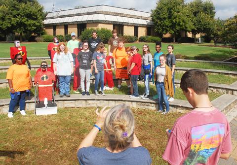 Vicky Carter, center, takes a photo of SkillsUSA students in October 2018 after they put up their “Incredibles”-themed scarecrows for last year’s Scarecrow Bash.