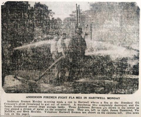 In this faded image on newsprint, Anderson firefighters fight a fire in Hartwell at the Standard Oil Company in 1944. 