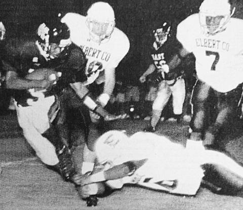 File photo Tino Stowers evades an Elbert County tackler in the Bulldogs’ 7-3 win over their rival in 1999.
