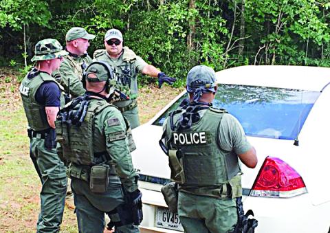 Photo submitted — The Hartwell Police Department SWAT team conducts a training exercise on how to tactically surround a vehicle. 