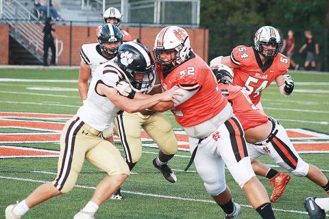 Sunshot by Grayson Williams — Gabriel Coker, No. 52, blocks for running back Malachi Thomas on a play in which Thomas broke a big run for a touchdown. 