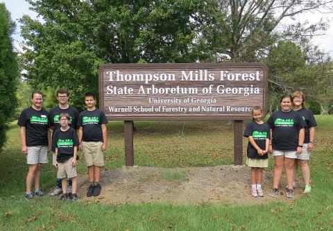 Photo submitted — 4-H’ers pose for a photo at the Thompson Mills Forest State Arboretum in Braselton. They are, from left to right, coach Ruth Daniel, Kaleb Waddell, Charlie Jones, Ashleigh Jones, Emma Shiflet, coach AnnaMarie Harrison. Standing in front is Aric McBride.