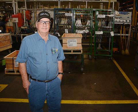 Sunshot by Michael Hall — George Adams poses for a photo in the factory at Tenneco where he has worked since 1959. He will retire when the plant closes later this year. 