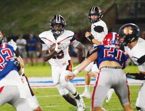 File photo — Malachi Thomas looks for running room in last year's game at Jefferson. 