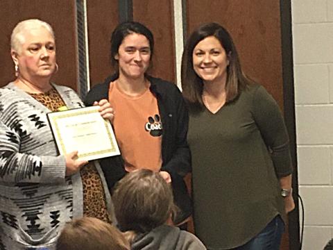 Denise Childs, left, and Nicole Wheless, right, present special education teacher Ashley Mccurley with a certificate for the Joey Childs Classroom Grant. Photo submitted