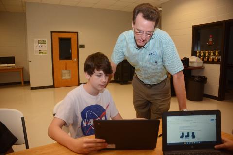 Sunshot by Michael Hall — Seventh-grader Wyatt Zimmerman, left, shows HTC president Randy Daniel his work recently at Hart County Middle School. HTC is a regular supporter of the Hart County Charter System. 
