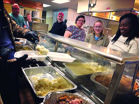 Photos submitted Volunteers at the 2018 Thanksgiving Dinner put on by Love Him Love Them Ministry serve food. 